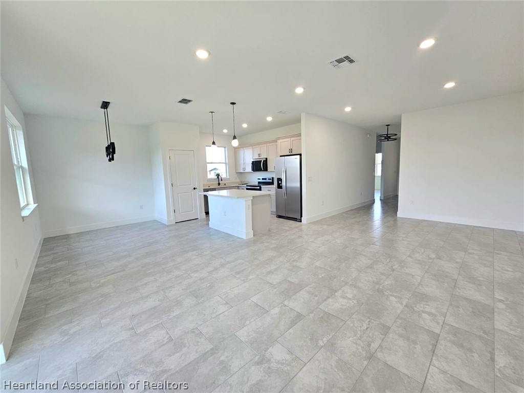 7324 Rolling Hills Road Sebring, FL 33876 - Photo 11 of 23 a view of a kitchen with a sink and stainless steel appliances