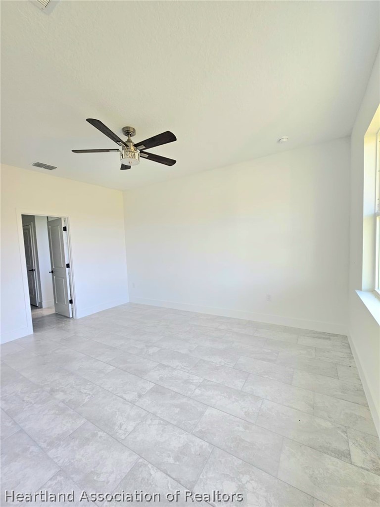 7324 Rolling Hills Road Sebring, FL 33876 - Photo 15 of 23 a view of a livingroom with a ceiling fan and window