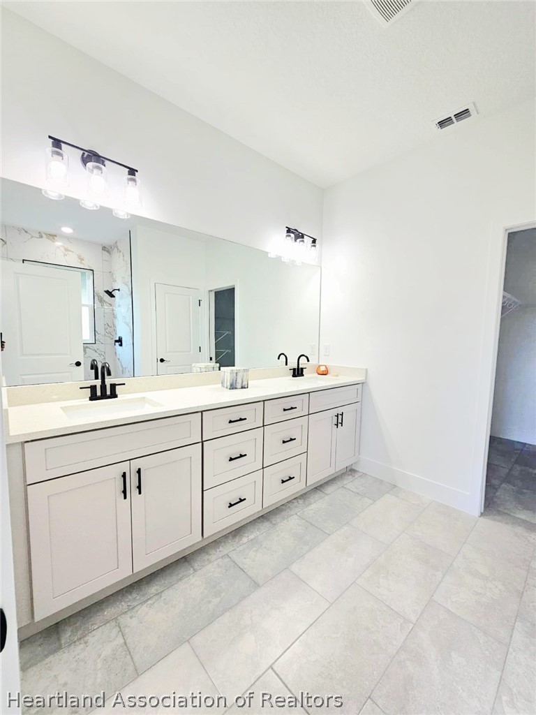 7324 Rolling Hills Road Sebring, FL 33876 - Photo 17 of 23 a spacious bathroom with a double vanity sink mirror and