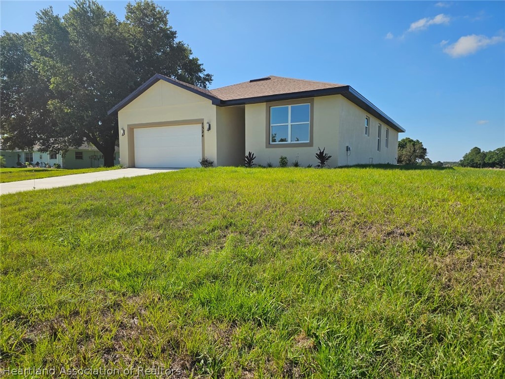 7324 Rolling Hills Road Sebring, FL 33876 - Photo 2 of 23 a view of a house with a yard