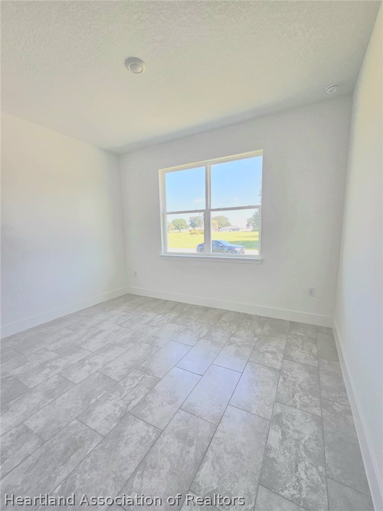 7324 Rolling Hills Road Sebring, FL 33876 - Photo 21 of 23 an empty room with a window