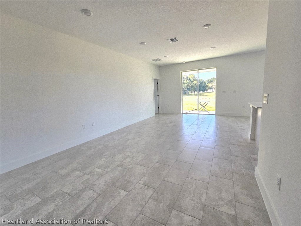 7324 Rolling Hills Road Sebring, FL 33876 - Photo 9 of 23 a view of an empty room with a window