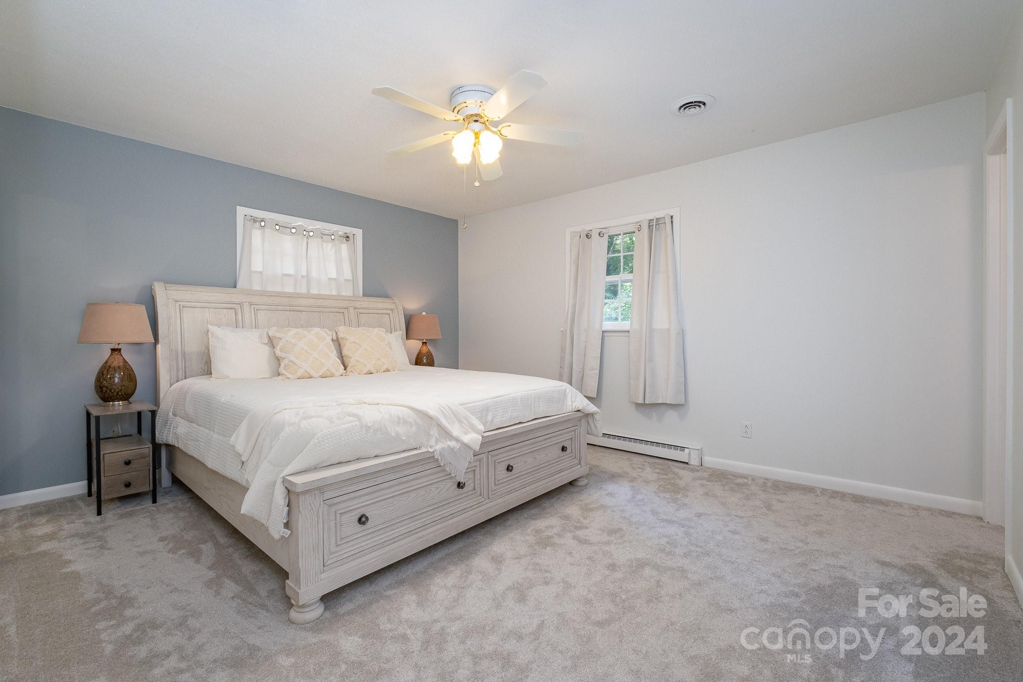 4081 Section House Road Hickory, NC 28601 - Photo 15 of 38 a spacious bedroom with a bed and a chandelier