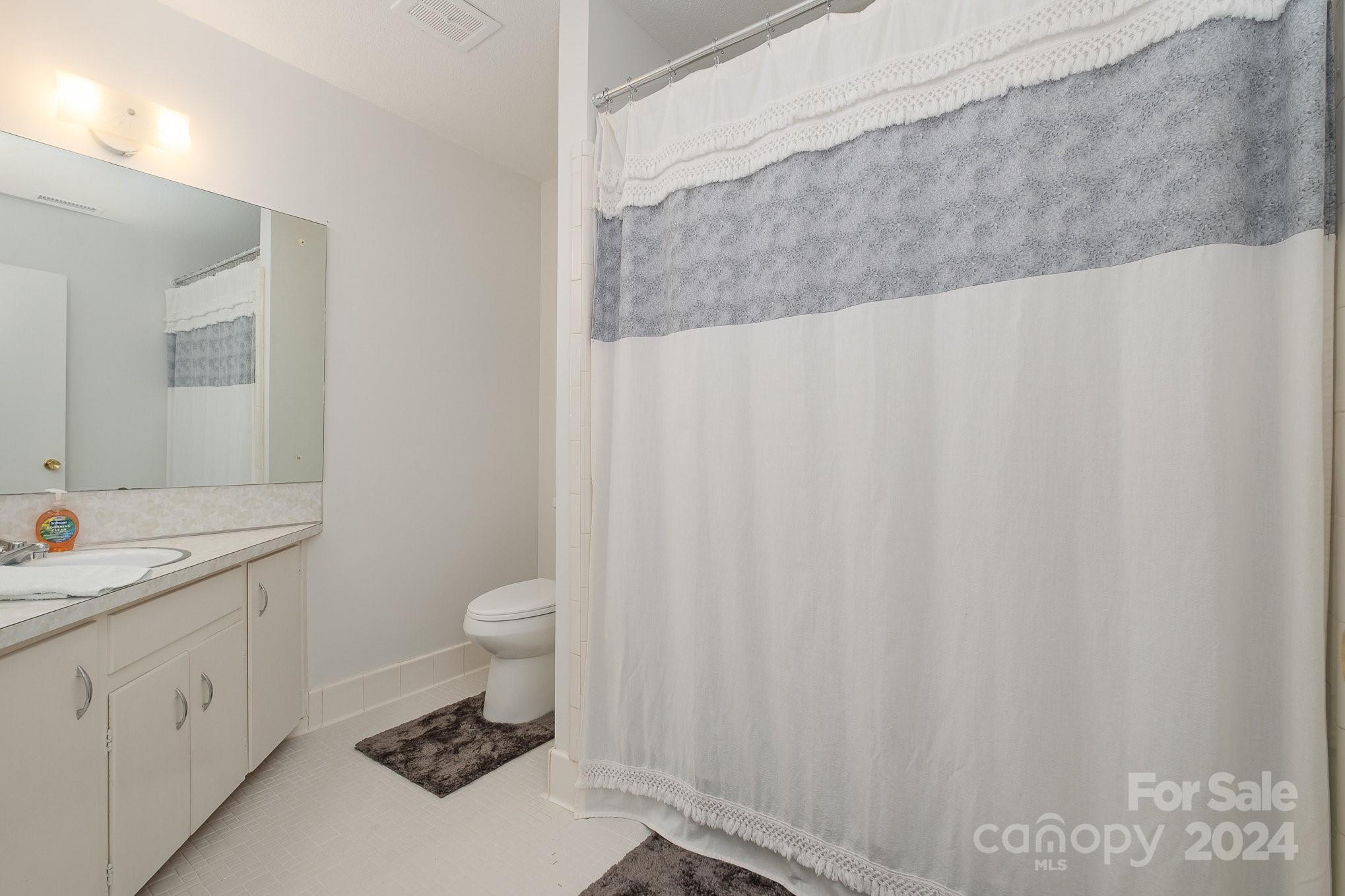 4081 Section House Road Hickory, NC 28601 - Photo 21 of 38 a bathroom with a granite countertop sink toilet and a mirror