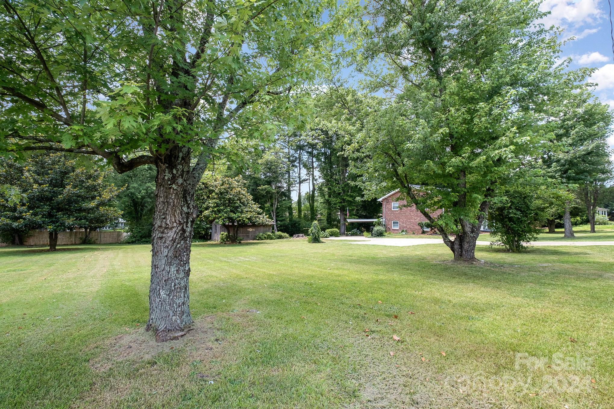 4081 Section House Road Hickory, NC 28601 - Photo 37 of 38 a backyard of a house with lots of green space and fountain