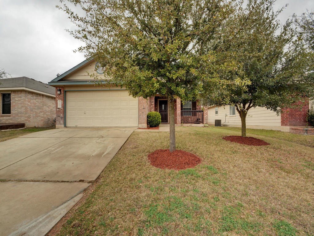17900 Violet Lane Elgin, TX 78621 - Photo 1 of 1 a front view of a house with a yard