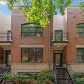 a front view of a house with a tree