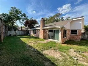 a view of a house with backyard and porch