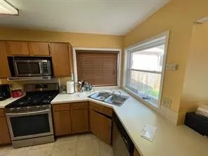 a kitchen with a sink stove and microwave