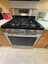 a close view of a stove top oven and a shower
