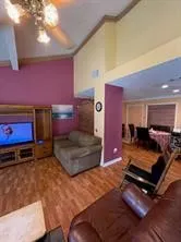 a bedroom with a bed and a flat tv screen on a dresser