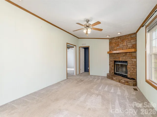 a view of an empty room with a fireplace