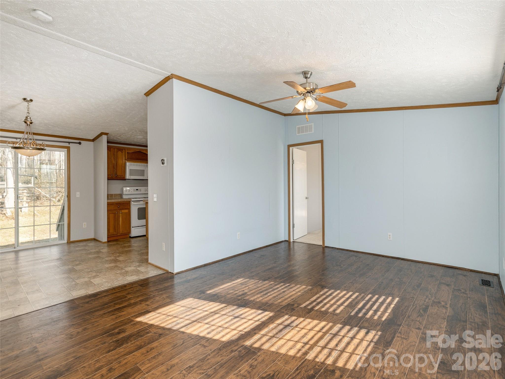 112 Lynn Estate Road Hendersonville, NC 28792 - Photo 4 of 24 a view of an empty room with window and wooden floor
