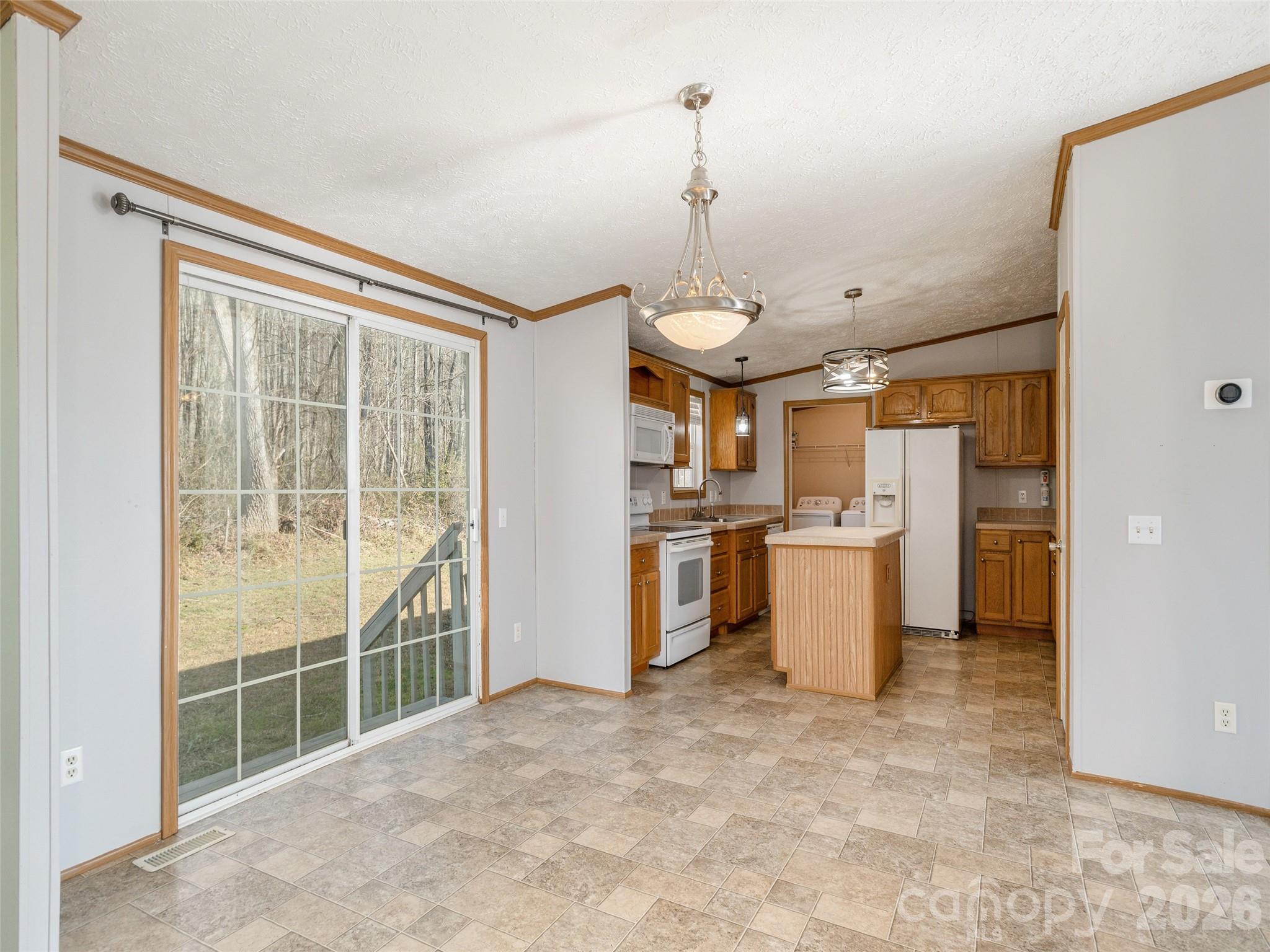 112 Lynn Estate Road Hendersonville, NC 28792 - Photo 6 of 24 a view of a kitchen with refrigerator and windows