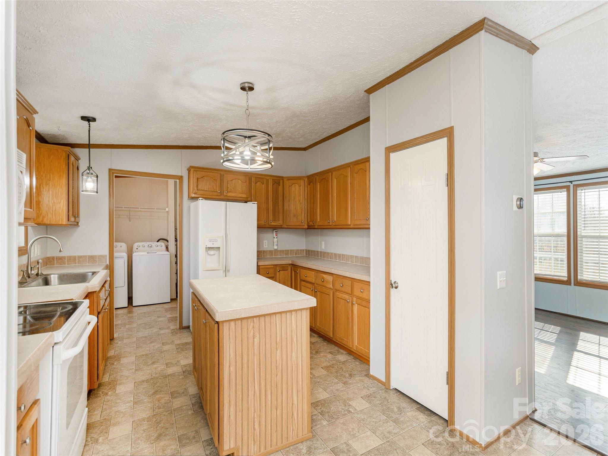 112 Lynn Estate Road Hendersonville, NC 28792 - Photo 7 of 24 a kitchen with a refrigerator a sink and dishwasher with a dining table