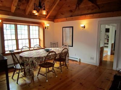 19 Higgins Hollow Road Truro, MA 02666 - Photo 11 of 34 a view of a dining room with furniture and wooden floor
