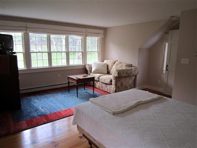19 Higgins Hollow Road Truro, MA 02666 - Photo 18 of 34 a bedroom with furniture and a wooden floor