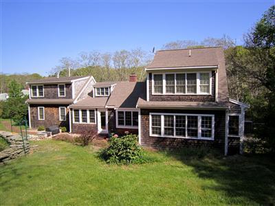 19 Higgins Hollow Road Truro, MA 02666 - Photo 2 of 34 a front view of a house with a yard