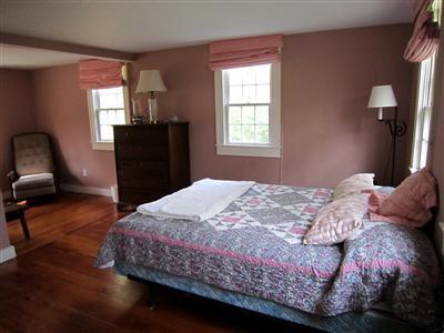 19 Higgins Hollow Road Truro, MA 02666 - Photo 21 of 34 a bedroom with a bed and wooden floor