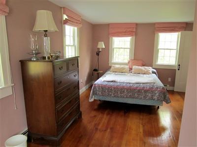 19 Higgins Hollow Road Truro, MA 02666 - Photo 22 of 34 a bedroom with a bed and wooden floor