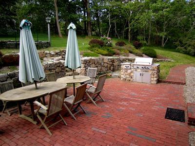 19 Higgins Hollow Road Truro, MA 02666 - Photo 4 of 34 a view of a patio with a table chairs and a backyard