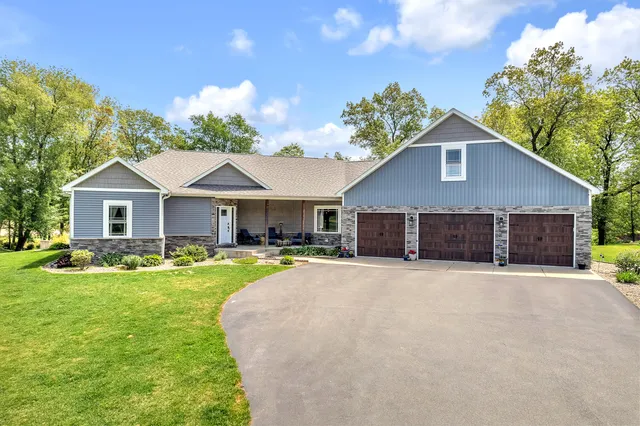 a front view of a house with yard and garage