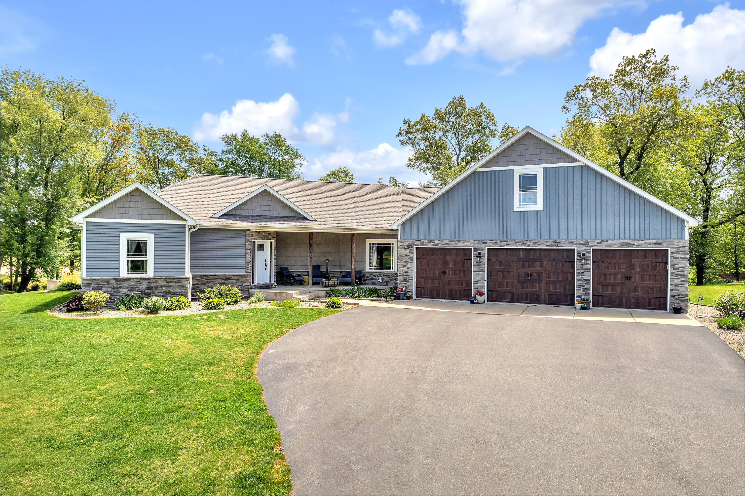a front view of a house with yard and garage