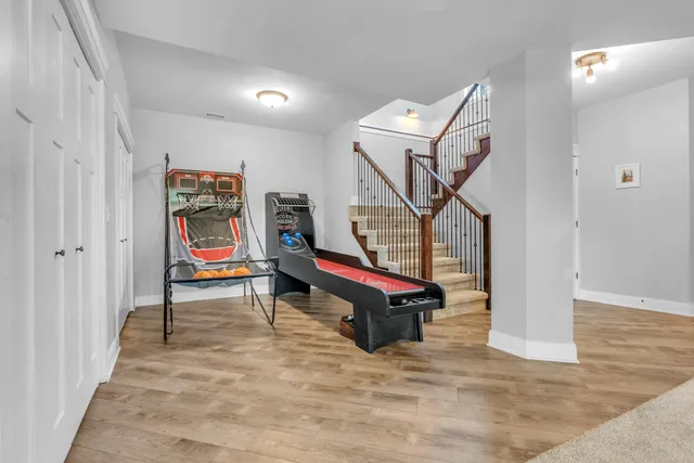 a view of a livingroom with wooden floor and stairs