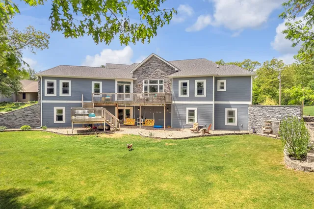 an aerial view of residential houses with outdoor space and lake view