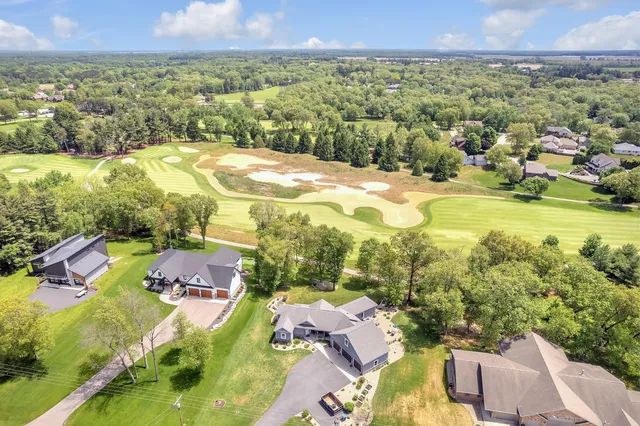 a view of a lake with a big yard and large trees