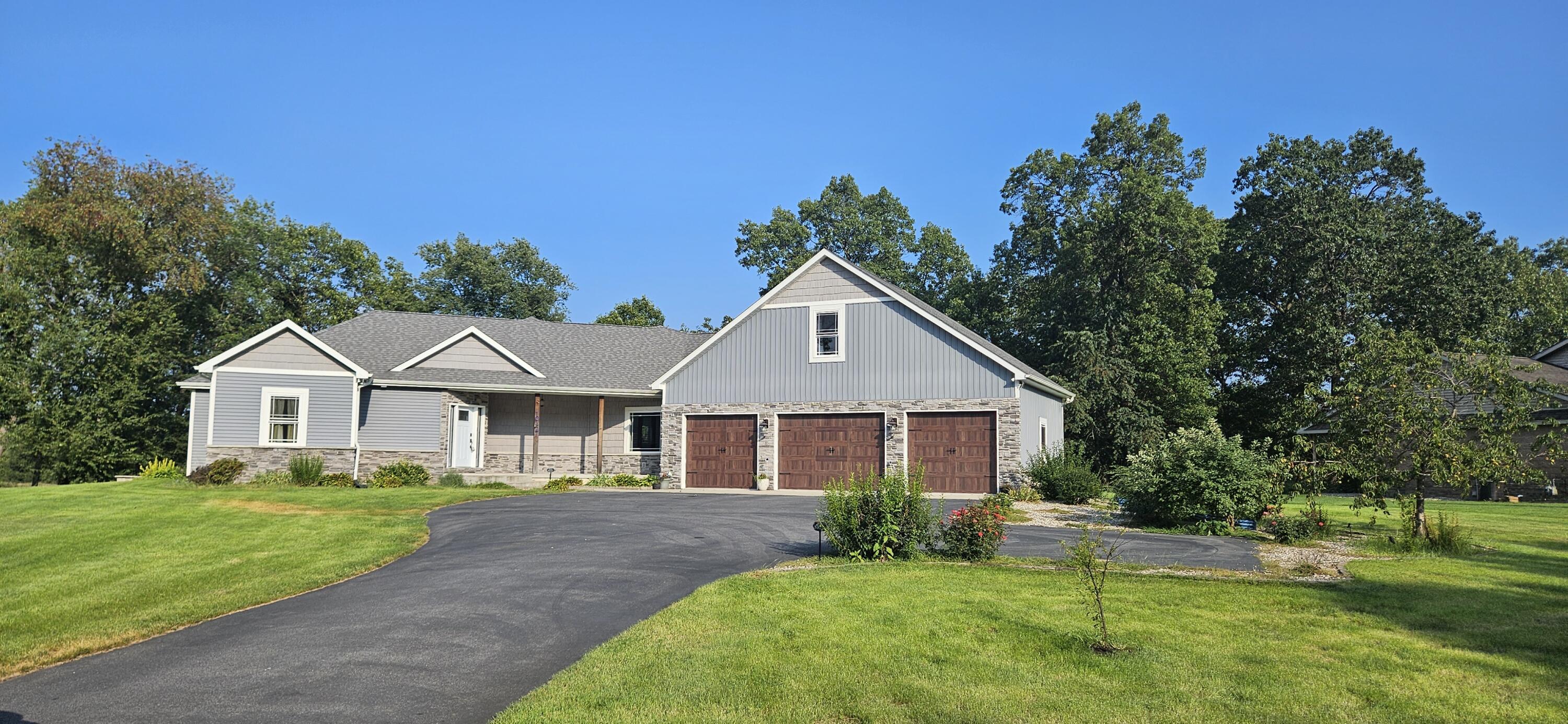 10427 North 600th Street West Demotte, IN 46310 - Photo 25 of 26 a front view of a house with a yard and trees