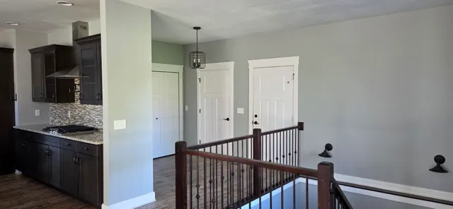 a view of a room with wooden floor and staircase