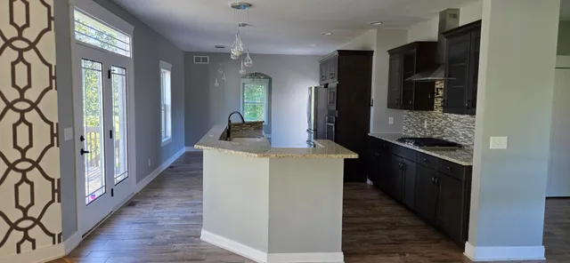 a kitchen with a granite countertop sink and window