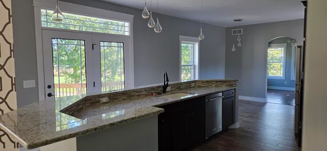 a kitchen with stainless steel appliances granite countertop a refrigerator and a sink