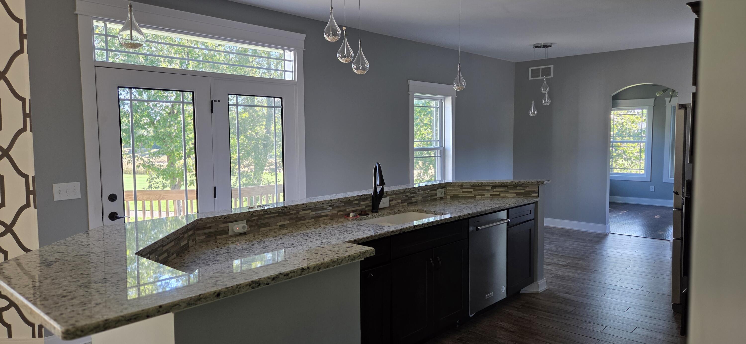 10427 North 600th Street West Demotte, IN 46310 - Photo 9 of 26 a kitchen with a granite countertop sink and window