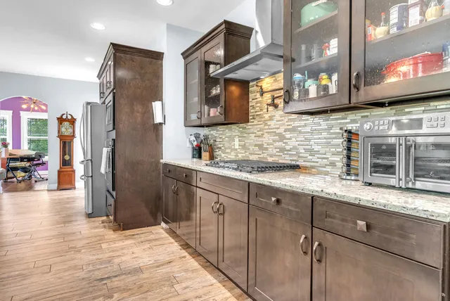 a kitchen with stainless steel appliances granite countertop a sink and cabinets