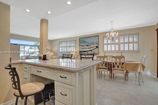 5440 Buchanan Street Hollywood, FL 33021 - Photo 11 of 34 a kitchen with stainless steel appliances granite countertop a table chairs sink and window