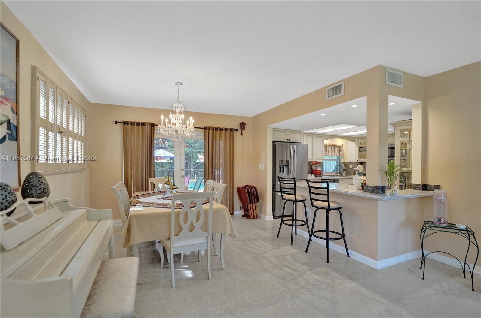 5440 Buchanan Street Hollywood, FL 33021 - Photo 13 of 34 a view of a dining room with furniture window and outside view