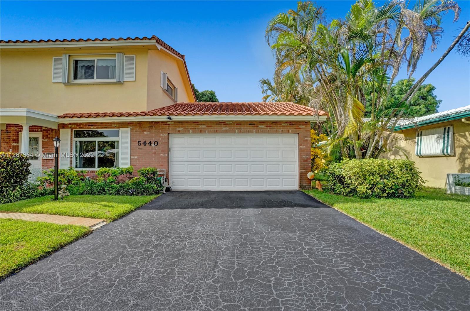 5440 Buchanan Street Hollywood, FL 33021 - Photo 2 of 34 a front view of a house with a yard and garage