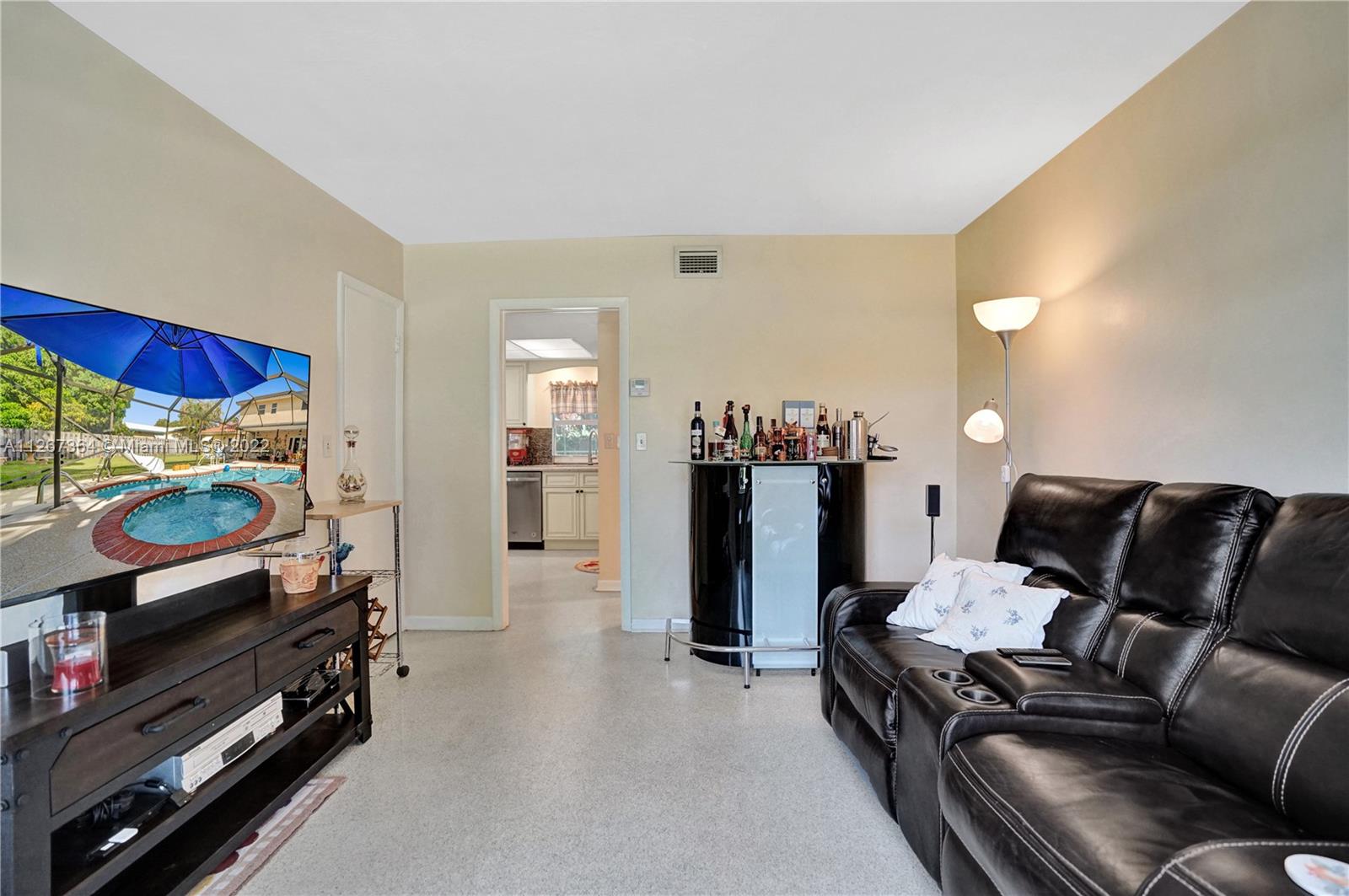 5440 Buchanan Street Hollywood, FL 33021 - Photo 25 of 34 a living room with furniture and a flat screen tv