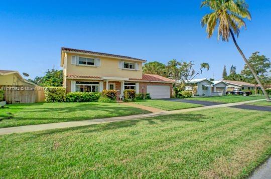 5440 Buchanan Street Hollywood, FL 33021 - Photo 33 of 34 a front view of house with yard and green space