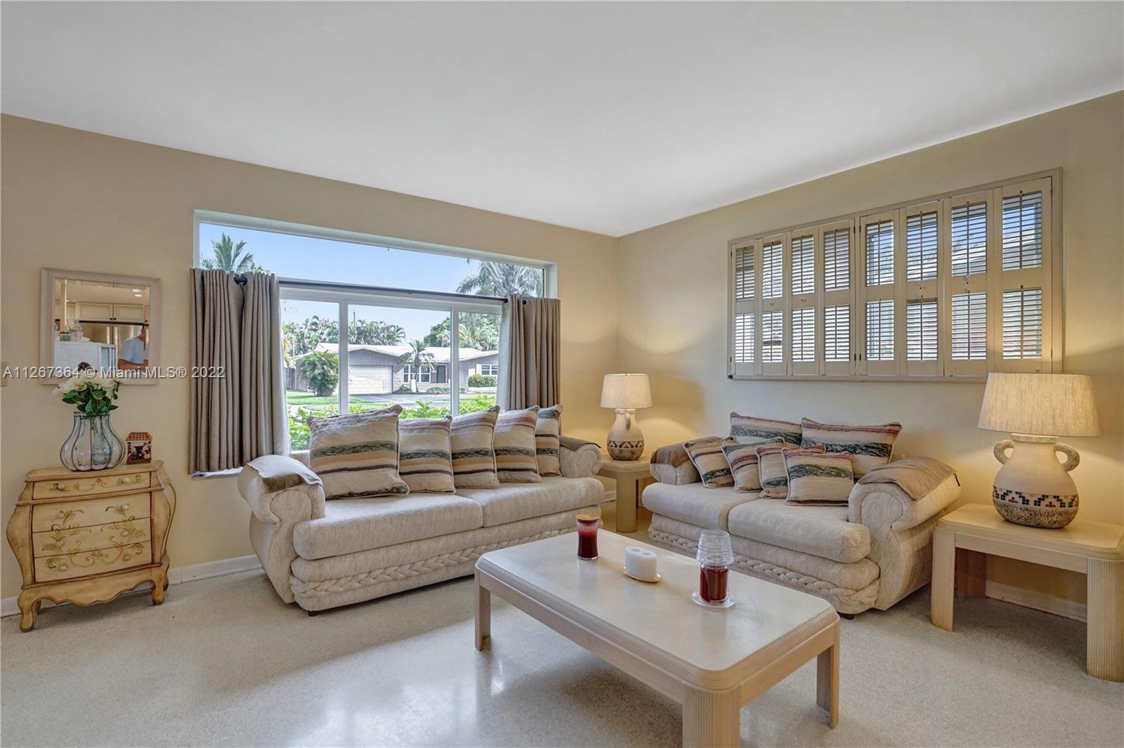 5440 Buchanan Street Hollywood, FL 33021 - Photo 4 of 34 a living room with furniture and a large window