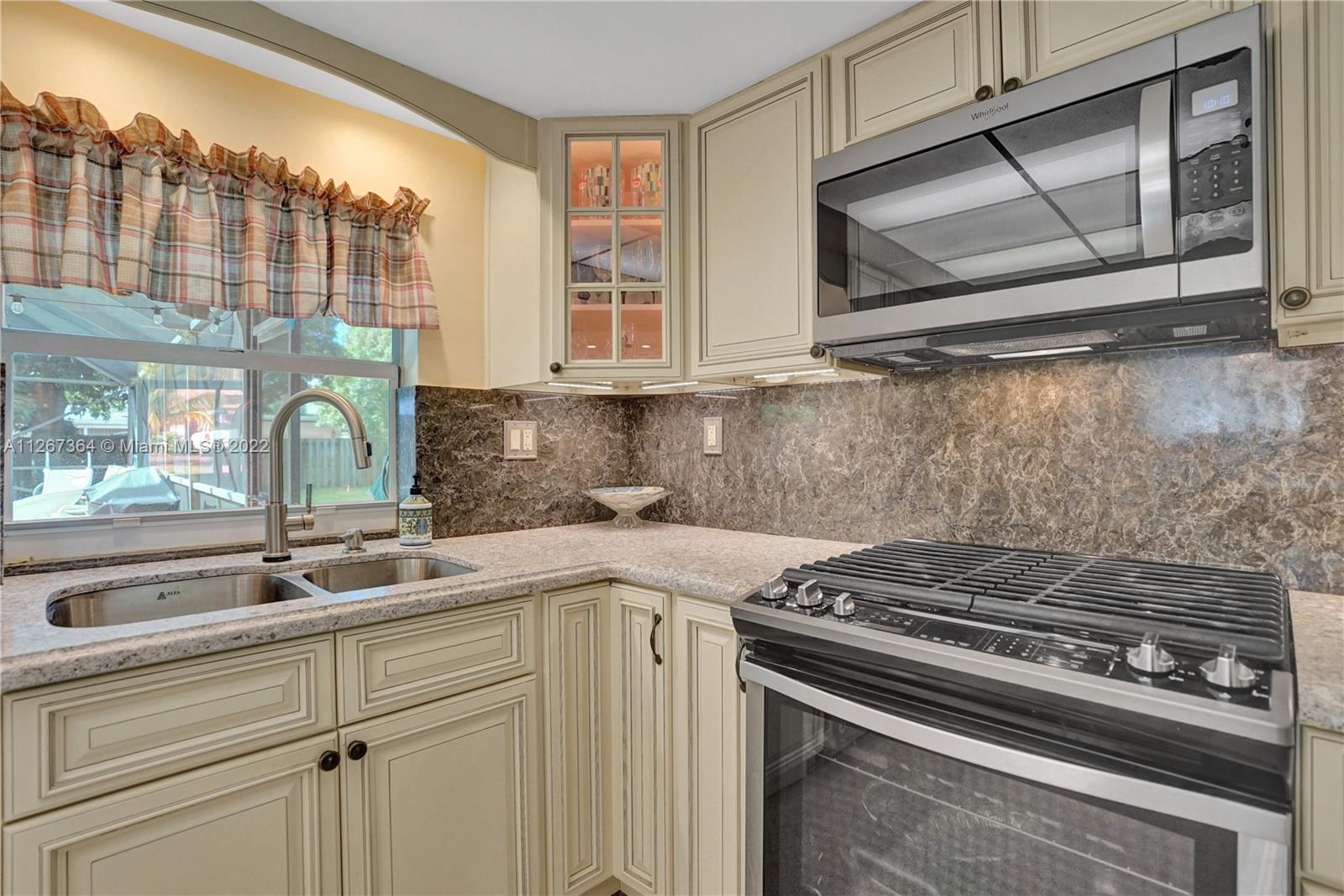 5440 Buchanan Street Hollywood, FL 33021 - Photo 7 of 34 a kitchen with a sink stove and cabinets
