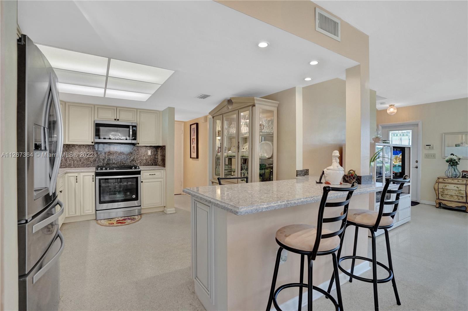 5440 Buchanan Street Hollywood, FL 33021 - Photo 8 of 34 a large kitchen with a table and chairs