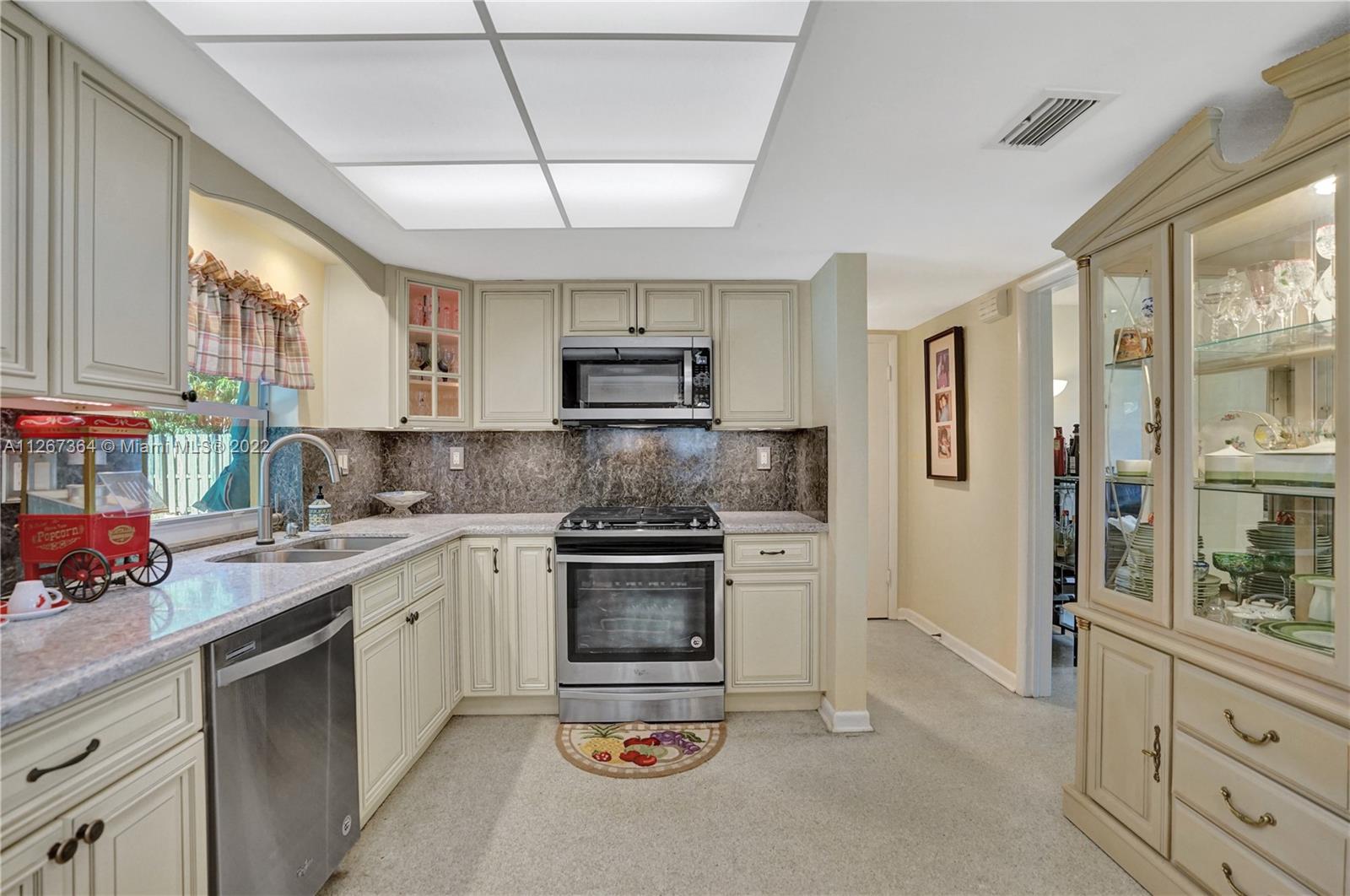 5440 Buchanan Street Hollywood, FL 33021 - Photo 9 of 34 a kitchen with stainless steel appliances granite countertop a stove and a sink