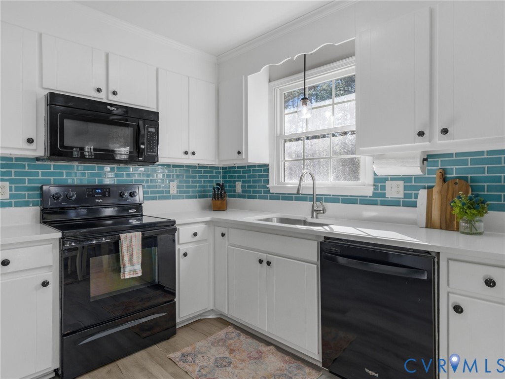 206 Rustic Drive Carson, VA 23830 - Photo 20 of 51 a kitchen with stainless steel appliances granite countertop a sink stove and microwave