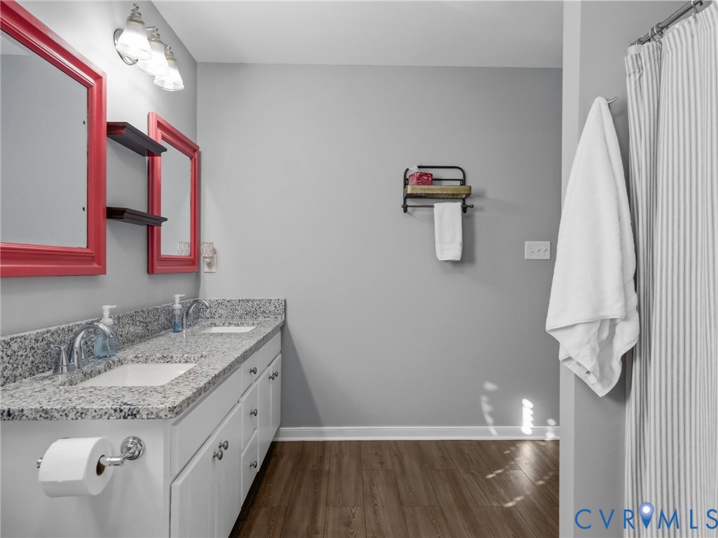 206 Rustic Drive Carson, VA 23830 - Photo 33 of 51 a bathroom with a granite countertop sink and a mirror