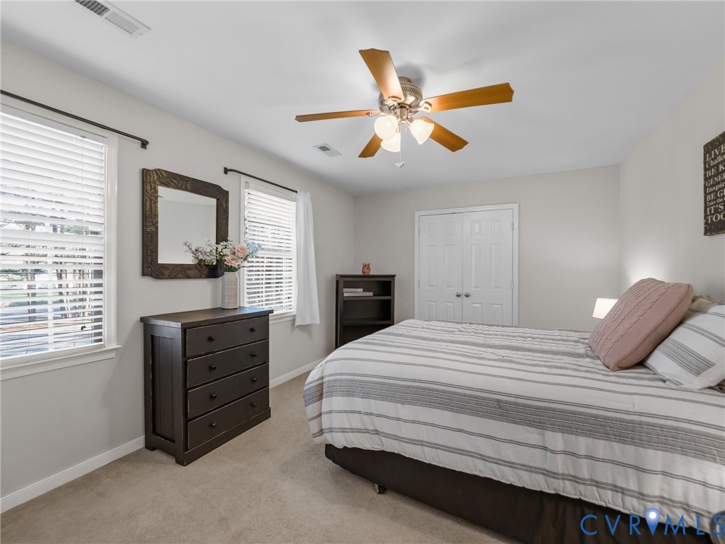206 Rustic Drive Carson, VA 23830 - Photo 38 of 51 a bedroom with a bed and wooden floor