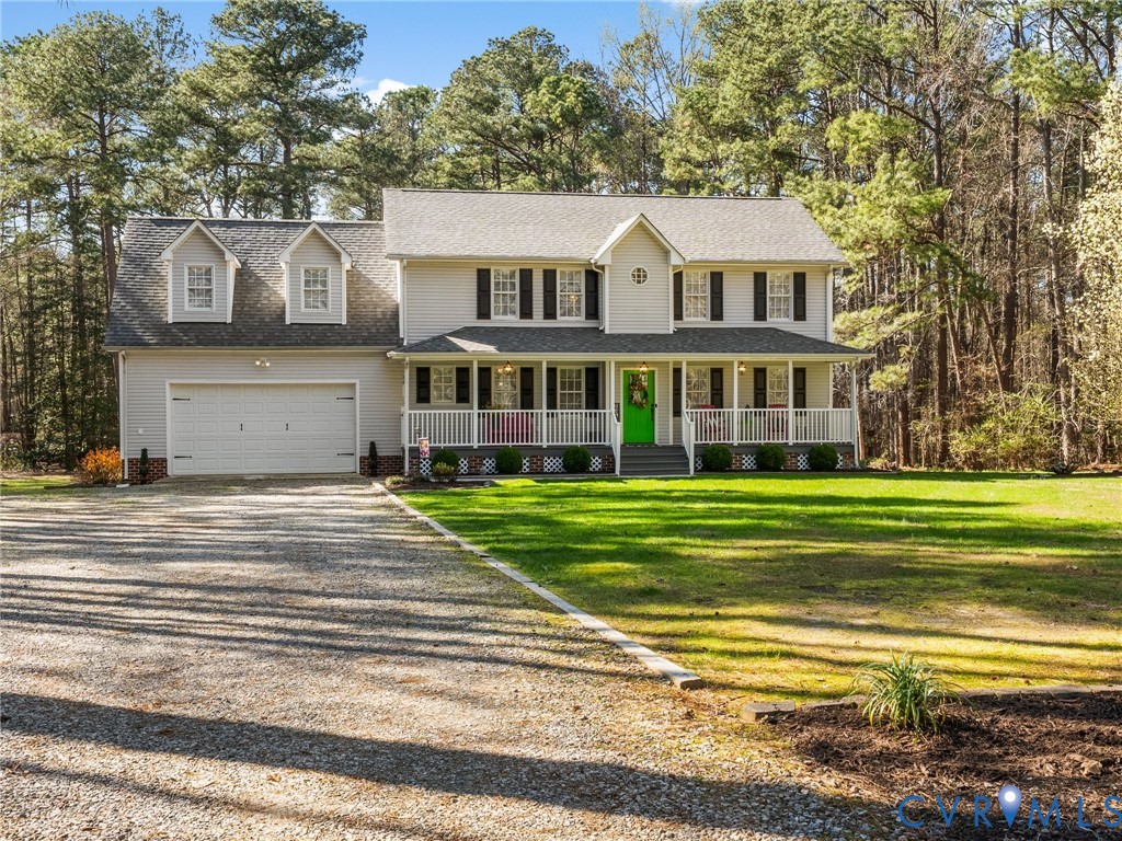 206 Rustic Drive Carson, VA 23830 - Photo 50 of 51 a front view of a house with a garden and trees