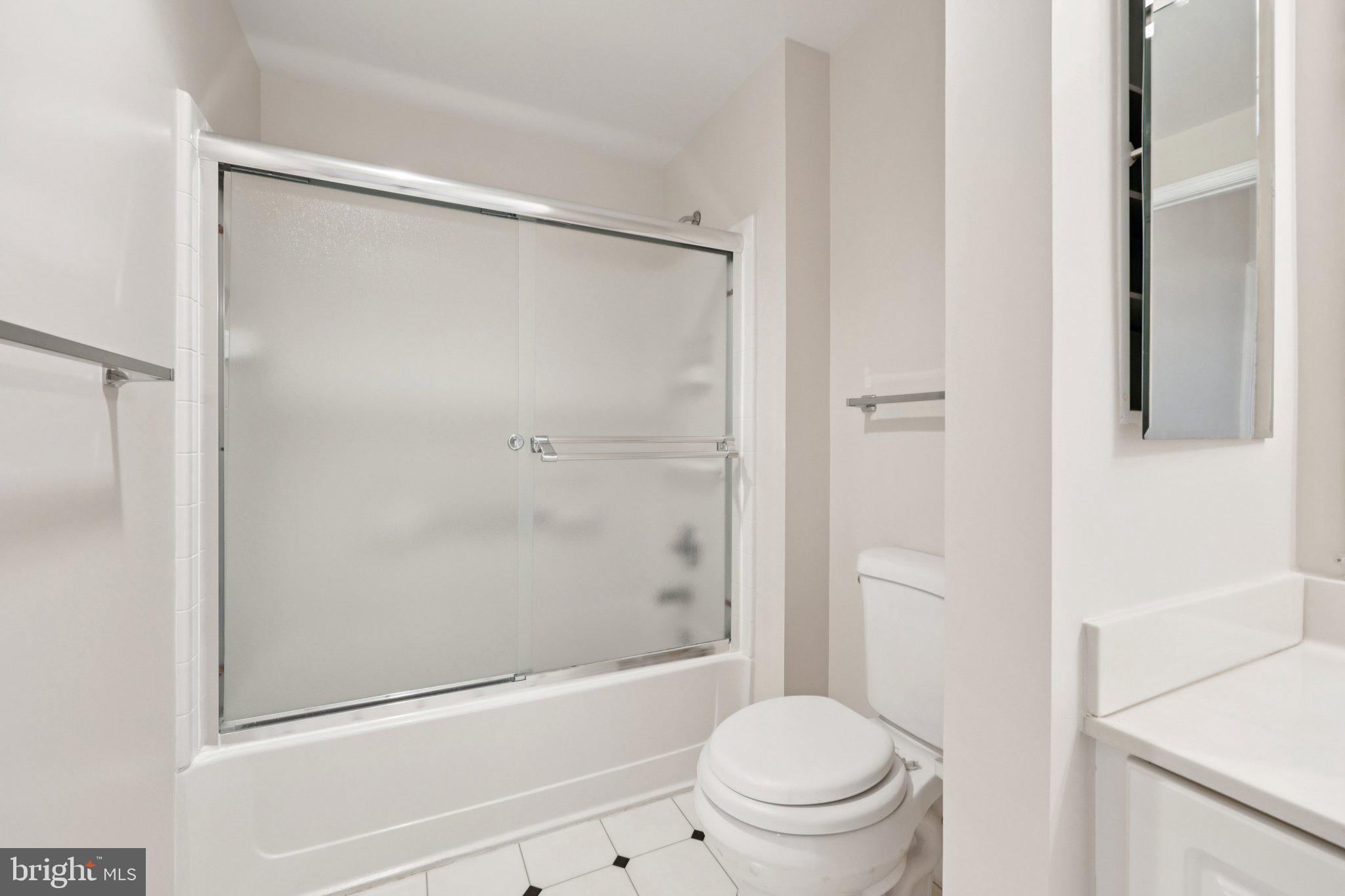 19375 Cypress Ridge Terrace, Unit 1111 Leesburg, VA 20176 - Photo 15 of 35 a bathroom with a shower a toilet and a shower